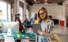 A lady looking like an Invigilator holding a tablet